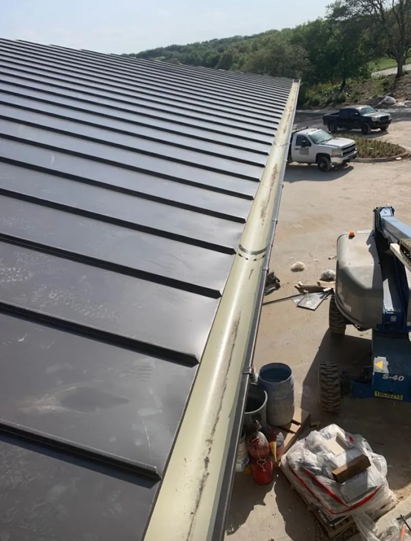 Standing seam panel and gutter detail on a metal roofing jobsite in Imperial